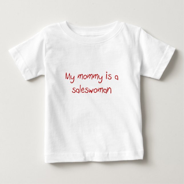 A mamãe é uma camiseta de bebê da mulher vendedora (Frente)