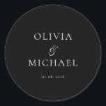 Adesivo Chic Script Black Minimalist Wedding<br><div class="desc">Add a personal and elegant touch to your wedding favors, envelopes, or packaging with this minimalist round sticker featuring your custom name in a graceful script font. Designed to complement a modern and timeless wedding theme, this classic black-and-white design pairs beautifully with any part of your celebration. Perfect for sealing...</div>
