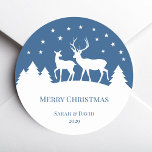 Adesivo Deer Stag & Doe Blue White Christmas<br><div class="desc">There is a blue and white illustration: white silhouettes of a deer stag and doe on a snowy hill, with pine tress on the sides and stars above. The sky is classic blue, as in a starry night, all the rest is white, in silhouette. The text is also blue: "Merry...</div>