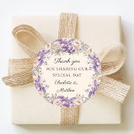Adesivo Lavender florals cream champagne wedding thank you<br><div class="desc">Decorate your wedding favors with this elegant floral sticker. It features a lush wreath of lavender and champagne-colored peonies in a soft watercolor style. These labels are perfect for sealing envelopes or adding a polished finishing touch to guest favor boxes.</div>