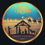 Adesivo Natal Dourado personalizado "Feliz Natal"<br><div class="desc">Silhouette Dourada e personalizada "Feliz Natal" Adicione um toque de beleza sagrada aos seus presentes de Natal e saudações com este elegante adesivo de Natal da cena da Natividade, um design único para você! Este adesivo redondo apresenta uma silhueta serena Natividade retratando Maria, José e Jesus bebê na mangueira, acompanhada...</div>