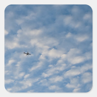 Adesivo Quadrado Airplane Crossing a Cloud-Filled Blue Sky