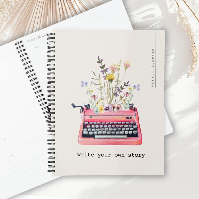 Agenda Escreva sua própria história, Beige Weekly Diary (Weekly Diary Planner with cover text "Write your own story" alongside a typewriter & florals graphic)