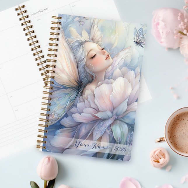 Agenda Peônia Do Amanhecer (Peony Of The Dawn Planner in a table next to a cup of cappuccino)