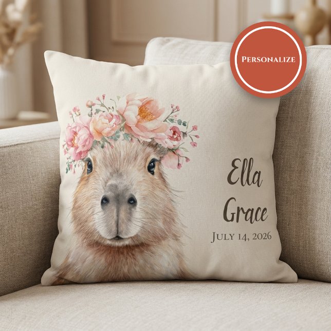 Almofada Capybara Baby Nursery • Personalized  (soft nursery pillow with floral capybara illustration on beige sofa setting)