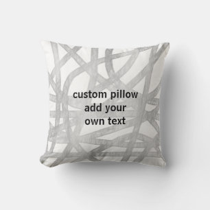 Almofada cinza e design pintado branco adicione o texto da