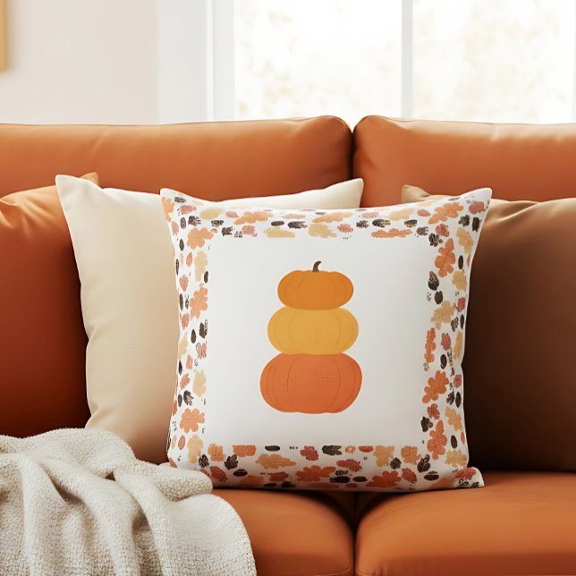 Almofada Decência de Queda do Armário de Bompkins Empilhado (Autumn pumpkin pillow with leaf pattern brings charm to a cozy warm-toned sofa.)