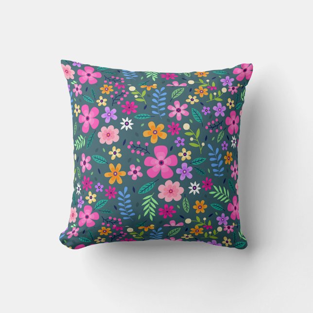 Almofada Flor Art (A square throw pillow features a dense, colorful floral pattern against a dark teal background.)
