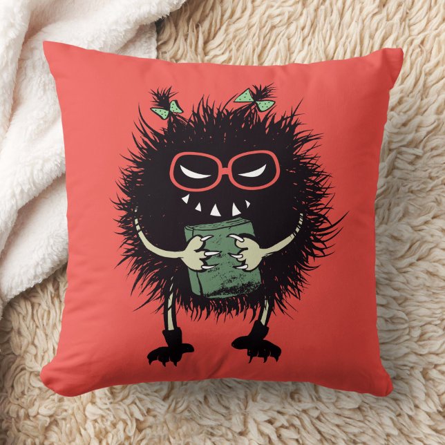 Almofada Mau Book Lover Character - Leitura Acentuada (orange red pillow with an evil character with eyeglasses and ponytails grinning and holding a book)