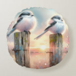 Almofada Redonda Pastel Watercolor Birds Fencepost Sunset<br><div class="desc">Soft watercolor brushwork captures two fluffy songbirds resting on weathered fence posts as a glowing sunset spreads across a dreamy countryside sky. Gentle washes of peach, blush pink, pale blue, and warm gold blend into a tranquil horizon, creating a calm pastoral atmosphere. The birds appear round and feathery, their delicate...</div>