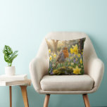 Almofada Robin Singing Into a Daffodil<br><div class="desc">In a sunlit garden, a robin sings atop a moss-covered rock into a yellow daffodil, surrounded by blooming bluebells and daffodils in springtime</div>