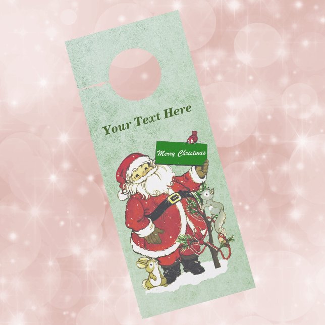 Aviso De Porta Papais noeis Tradicionais Pássaros com Neve Verde (Santa in snow with animals and birds holding Merry Christmas sign on paper door knob hanger.)