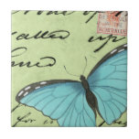 Azulejo De Cerâmica Borboleta de asa azul no cartão postal<br><div class="desc">Este cartão postal teal carregar uma mensagem de beleza. Uma delicada borboleta de asas azuis repousa no cartão,  ocultando alguns dos escritos que contém. Este impressão do Vision Studio faria um excelente adicional para sua casa!</div>