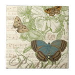 Azulejo De Cerâmica Borboletas em Música Folha com Design Floral<br><div class="desc">Um design floral verde e uma partitura musical servem de fundo para um trio de borboletas nesta peça do Vision Studio. A palavra francesa para a borboleta, o papillon, também está gravada no fundo da peça. Se você tem um forte amor por borboletas, natureza, ou como se rodeasse de beleza,...</div>