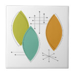 Azulejo De Cerâmica Meio século de Formas de Surfboard Verde Laranja<br><div class="desc">Este azulejo cerâmico moderno,  com forma turquesa,  verde e laranja,  e starbursts pretos,  irá adicionar um breque de cor ao seu projeto de unção ou como uma peça de sotaque.</div>