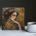 Azulejo De Cerâmica Ouro Fase Gustav Klimt Mosaic Edwardian Mulher C<br><div class="desc">Este belo azulejo cerâmico apresenta um trabalho de arte inspirado na "fase de ouro" de Gustav Klimt, representando uma mulher da era Edwardian. Nesse período, Klimt ficou fascinado pelos mosaicos bizantinos e desenvolveu sua técnica de mosaico com folha de ouro e cores vibrantes. Este trabalho de arte homenageia a abordagem...</div>