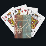 Baralho Quebrando<br><div class="desc">© Michael Mullan / Wild Apple. Uma imagem de uma bicicleta branca contra um fundo colorido. O fundo é uma colagem de quadrados em diferentes cores e tons.</div>