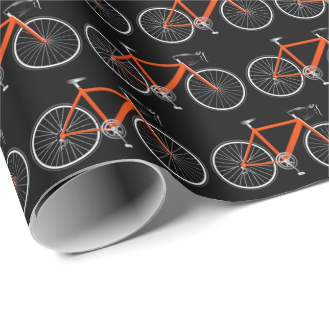 bicicleta laranja em papel de embrulho preto (Ponta do rolo)