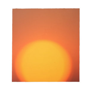 Bloco de notas alaranjado do por do sol
