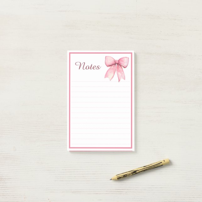 Bloco de Notas Cativante com Laço de Fita Rosa (Na mesa)