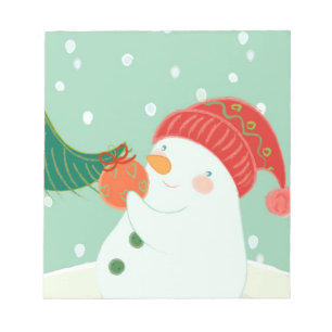 Bloco De Notas Um boneco de neve que pendura um ornamento em uma