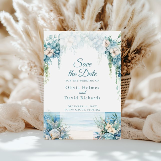 Boho Blue Floral Arch Beach Salve o cartão de data (Boho Blue Floral Arch Beach Save the Date Card on a sunny table in front of white pampas grass)