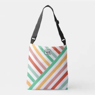 Bolsa de mão com listras coloridas e monograma