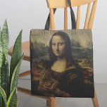 Bolsa Tote A Meow Lisa<br><div class="desc">O Meow Lisa Tote Bag - Já se perguntou qual é a razão desse misterioso sorriso de Mona Lisa? Em segundo lugar, temos a resposta. Esta obra-prima absoluta de uma bolsa de tote apresenta a mais conhecida obra de arte do mundo "escovando-a", e tendo algum tempo de qualidade com um...</div>