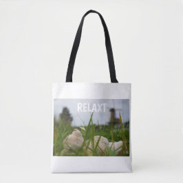 Bolsa Tote Beer relaxt liggend in het gras met een Hollandse 