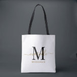 Bolsa Tote Branca de Manteiga Dourada de Presente Preto<br><div class="desc">Esta mala de tote da Bridesmaid apresenta um monograma escrito à mão de ouro e uma escrita preta com cinzas num fundo branco. Apresente suas madrinhas com um bolsa para os artigos de carregando no dia do casamento,  e tradicionalmente apresentadas no janto de ensaio ou antes.</div>