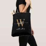 Bolsa Tote Elegante negro Dourado, personalizado, monograma<br><div class="desc">Simples Elegante Moderno Negra e Monograma Dourado Nome Inicial Script de Assinatura Personalizado Tote Bag. Este design com seu primeiro nome em uma tipografia de fontes (ou caligrafia) com estilo simples, escrito à mão bonito, com o nome inicial e familiar do monograma ou o nome do cheio em ouro e...</div>