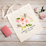 Bolsa Tote Flores de Aquarelas Rosa Monograma de Casamento de<br><div class="desc">O design de saco tote personalizado apresenta um monograma dos nomes noiva e noivo e data de casamento com uma bela design de buquê floral pintada com cor-de-água pastel rosa,  pincel,  primavera de pêssego dahlia e rosa flores emparelhadas com uma folhagem verde vibrante.</div>