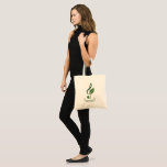 Bolsa Tote Heather Niemi Savage Logo Tote Bag<br><div class="desc">Support a composer by buying merch! Show off your love of music with a tote bag displaying my logo on a mint green background. My treble clef with a leaf logo in a dark sage green represents my work as both a musician and an herbalist. The 5 ripples represent the...</div>