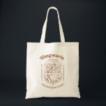 Bolsa Tote HOGWARTS™ School of Witchcraft and Wizardry Crest<br><div class="desc">Honor the legacy of the wizarding world with this timeless Hogwarts™ School of Witchcraft & Wizardry crest design. Featuring the iconic four-house shield — lion, serpent, badger, and eagle — this elegant artwork represents the unity and tradition of Gryffindor™, Slytherin™, Hufflepuff™, and Ravenclaw™. Rendered in a refined, vintage-inspired line style,...</div>