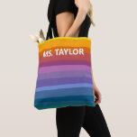 Bolsa Tote Modern Rainbow Stripes Teacher Name Gift<br><div class="desc">This tote bag features bold, cheerful horizontal stripes in a full rainbow gradient — from warm yellows and oranges through coral, pink, purple, and teal — with a personalized name printed in clean white lettering across the front. The bright, modern design makes it a fun and practical gift any teacher...</div>