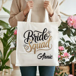 Bolsa Tote Personalized Gold Bride Squad Bachelorette Party<br><div class="desc">Get ready for the ultimate girls' getaway with this chic Bride Squad tote bag! Featuring elegant gold-toned typography and sparkling diamond accents, this bag is the perfect accessory for bachelorette weekends, bridal showers, or as a stylish wedding welcome bag. Durable and spacious, it's designed to hold all your party essentials...</div>