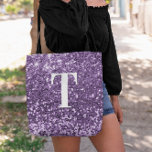 Bolsa Tote Roxo Faux Glitter Bokeh Sparkles Monograma<br><div class="desc">Um moderno monograma solteiro em branco com uma sombra negra. O tamanho, a cor e o estilo da fonte são personalizáveis. O fundo é um brilho púrpura falso com pontos cintilantes ou bokeh. Mova ou exclua os gráficos pequenos e falsos. Um belo presente para uma dama de honra ou outro...</div>