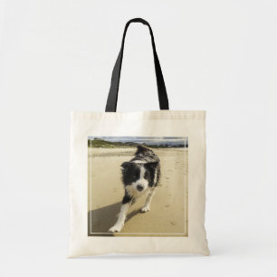 Bolsa Tote Um cão de border collie que funciona na praia