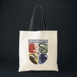 Bolsa Tote Vintage HOGWARTS™ Stamped Crest<br><div class="desc">Show your house pride in bold, vintage-inspired style with this striking Hogwarts™ crest design. Featuring graphic silhouettes representing the four iconic houses — Gryffindor™, Slytherin™, Hufflepuff™, and Ravenclaw™ — this artwork blends classic symbolism with a modern, retro aesthetic. Each house emblem is set within a clean, color-blocked shield, creating a...</div>