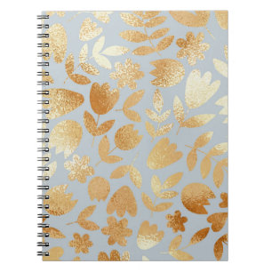 Caderno Espiral Douradas flores, fundo azul, imitação de folhas.