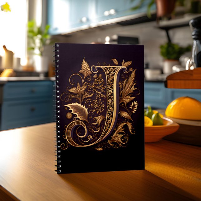 Caderno Espiral Monograma - Letra J (Notebook with monogram letter J stands on kitchen table)
