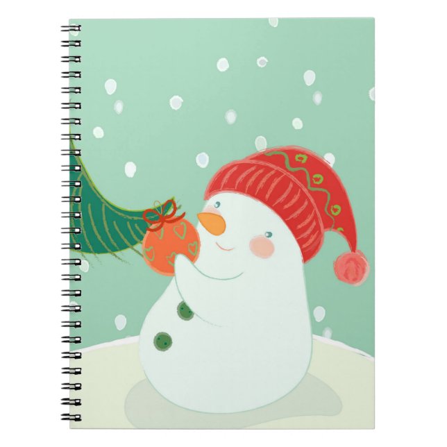 Caderno Espiral Um boneco de neve que pendura um ornamento em uma (Frente)