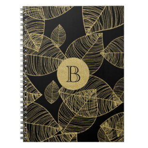 Cadernos de notas elegantes com folhas douradas em