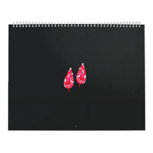 Calendário um par de folhas vermelhas sobre fundo preto