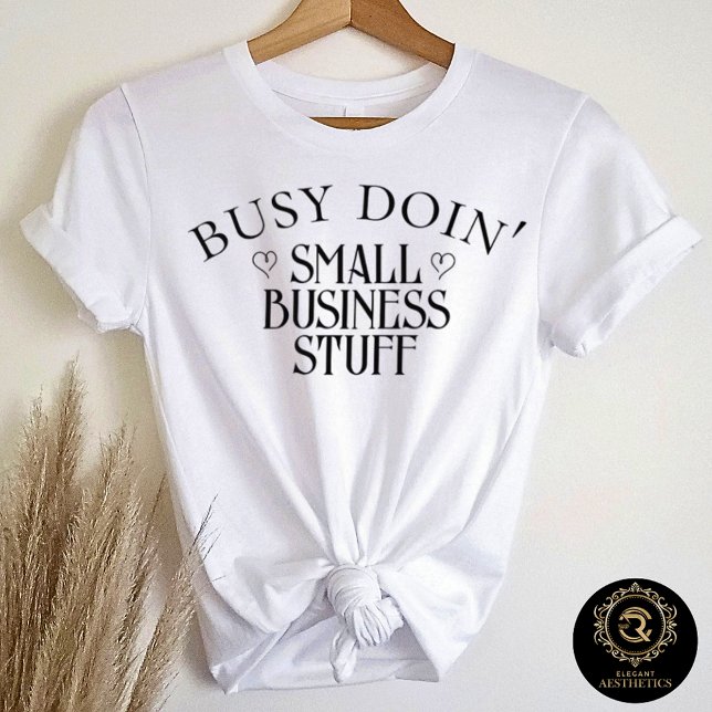 Camiseta Busy Doin' Small Business Stuff Bella (White t-shirt on hanger with quote "Busy Doin' Small Business Stuff")