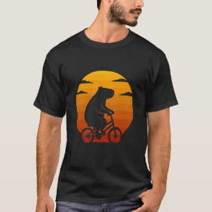 Camiseta Capivara andando de mountain bike pôr do sol vinta