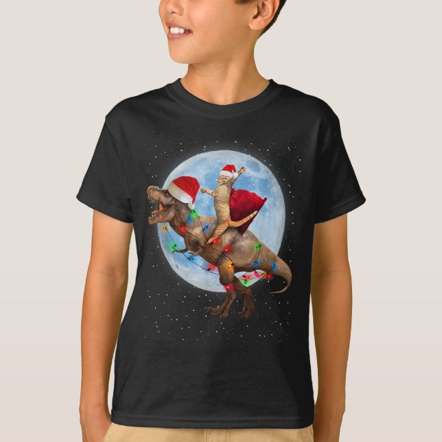 Camiseta Cat Santa Hat Andando Dinossauro T rex Lua Natal (Frente)