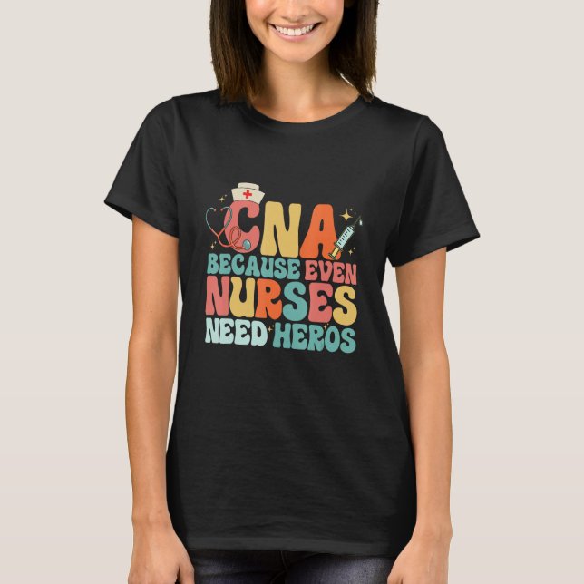 Camiseta CNA Humor Because Even Nurses Need Heroes  Nurse T (Frente)