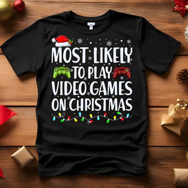 Camiseta É mais provável que JOGEM VÍDEOGAMAS NO NATAL (VIDEO GAMER PERFECT GIFT! FUNNY MOST LIKELY TO PLAY VIDEO GAMES ON CHRISTMAS FAMILY MATCHING T-SHIRT)