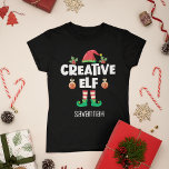 Camiseta Elfo criativo divertido com o nome da família nata<br><div class="desc">Perfeito para qualquer reunião de família de Natal, esta camiseta divertida apresenta um bonitinho chapéu de elfo e pernas minúsculas, com a legenda "Elfo criativo" em uma fonte branca moderna de bonés. Esta hilária e autoirônica camiseta elfo alegre, que faz parte de uma coleção de roupas elf da família que...</div>